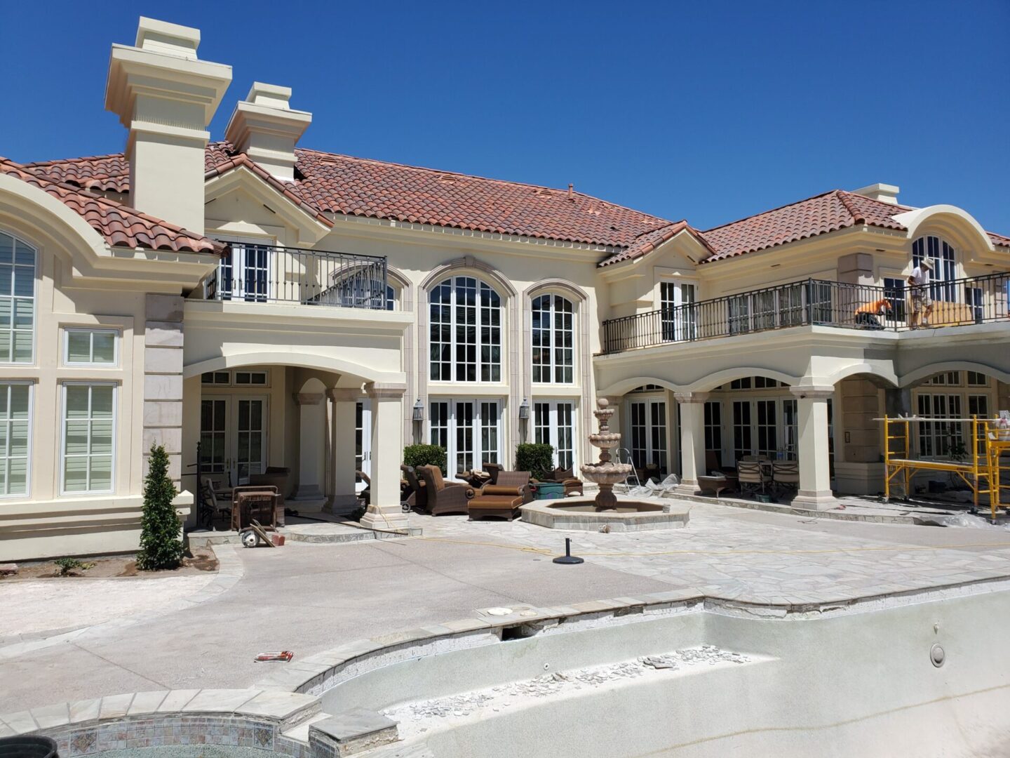 Luxurious mansion with Mediterranean architecture and a spacious patio area.