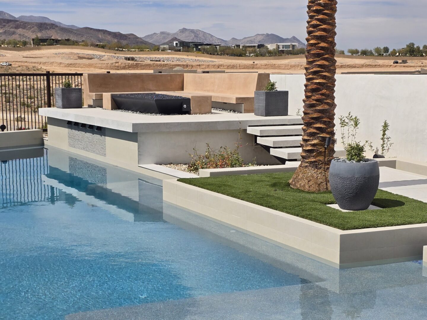 Modern outdoor pool area with clean lines and desert views.